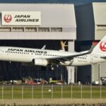 Japan Airlines Boeing 737 landing at hangar showing wing detail