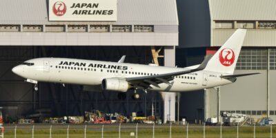 Japan Airlines Boeing 737 landing at hangar showing wing detail
